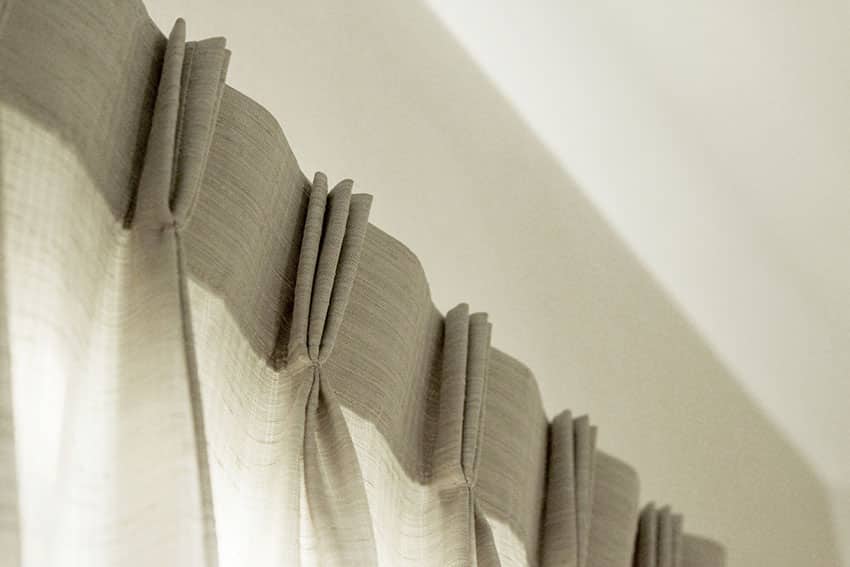 Beige curtain in pleated style