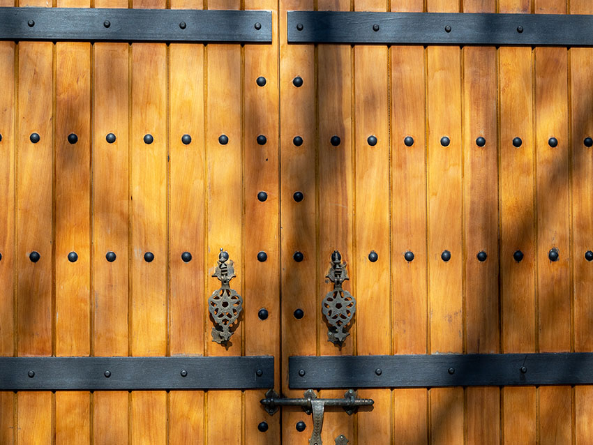 Wooden gate with metal fittings clavos nails