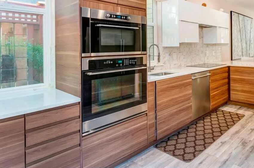 Quartz countertops, wooden cabinets, and modern laminated floor