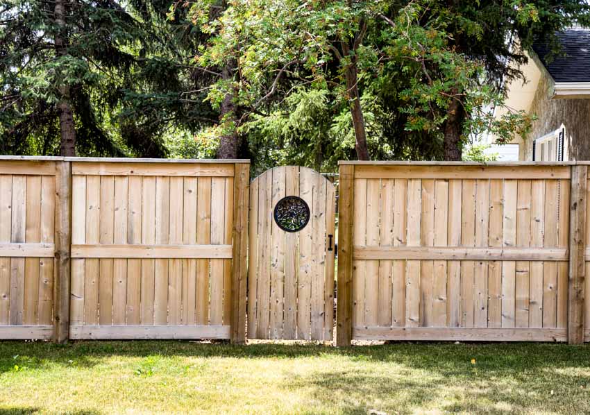 Backyard with wood gate and cedar fences