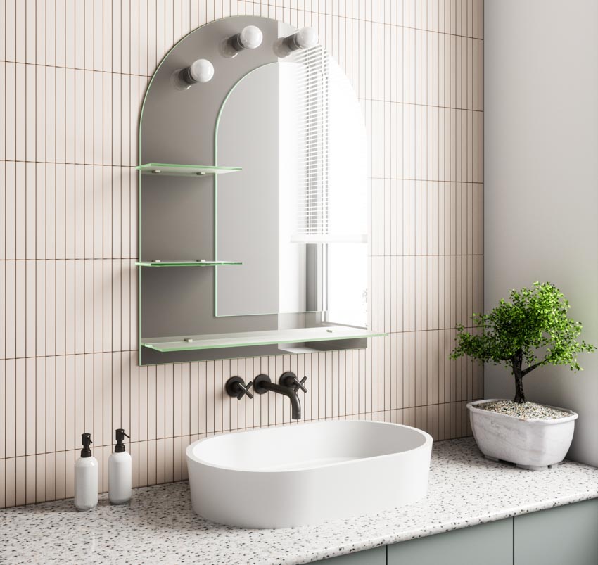 Bathroom with kit kat tile backsplash, countertop, sink, wall-mounted faucet, mirror, and indoor plant