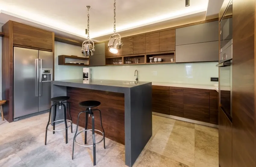 Kitchen with wooden modular cabinets, marble flooring and island with stools 