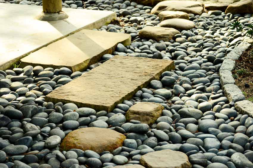 Beautiful walkway with landscaping beach pebble rocks
