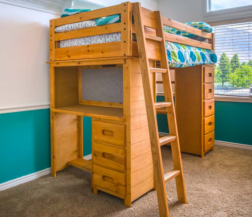 Bedroom with bunk bed, desk, ladder, window, and drawers