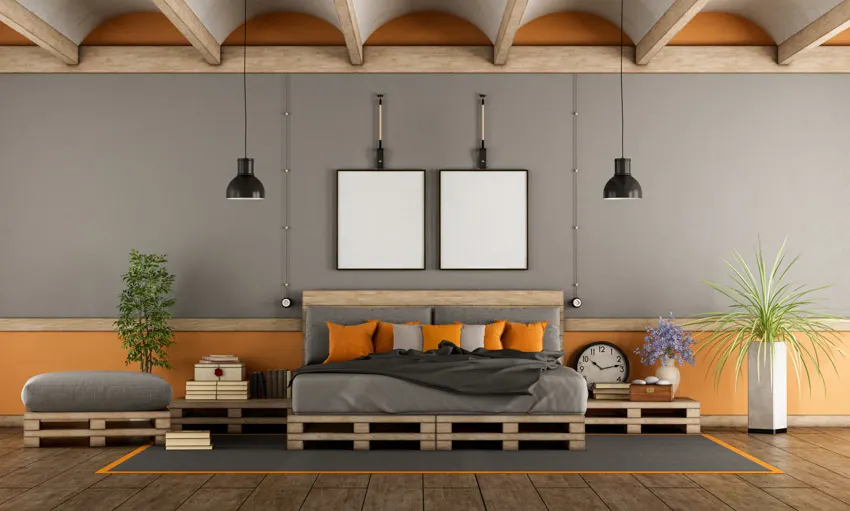 Bedroom with DIY wood pallet nightstands, rug, indoor plants, pillows, and hanging lights