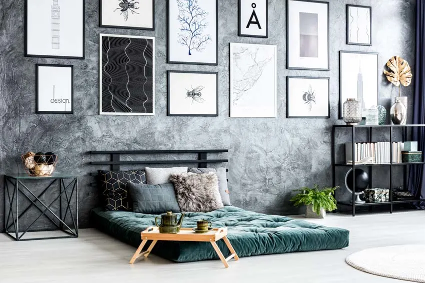 Bedroom with floor mattress, gray wall, and nightstand
