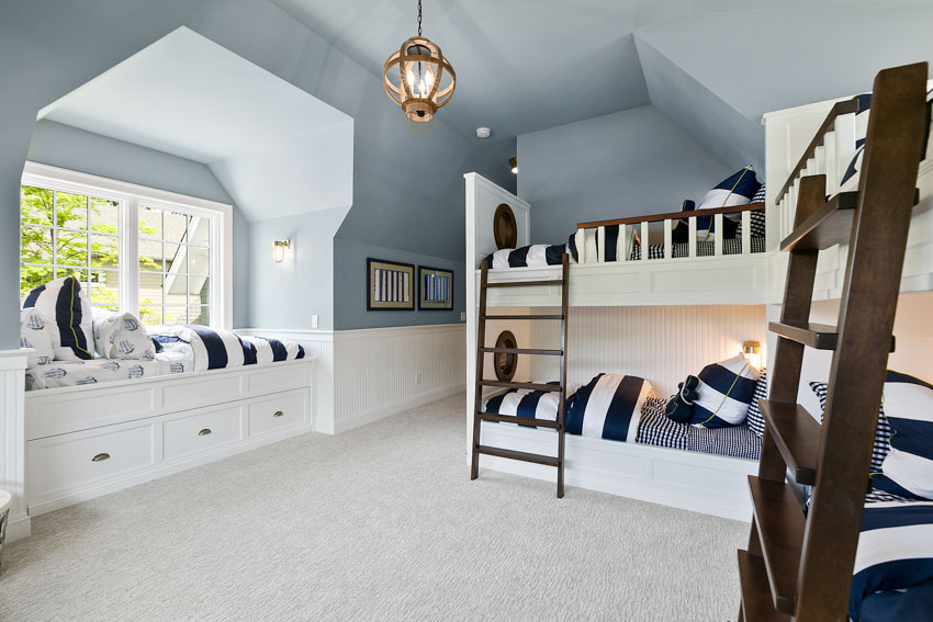 Bedroom with window, nook, bunk beds, blue ceiling, and hanging light