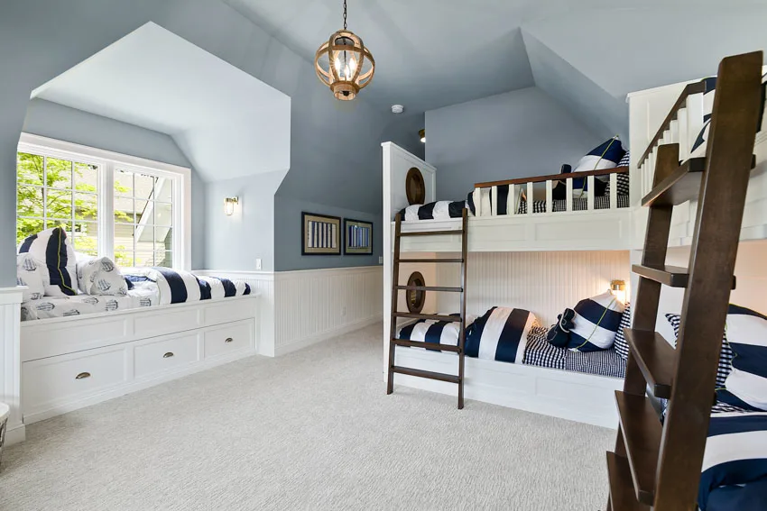 Bedroom with window, nook, beds, blue ceiling, and hanging light