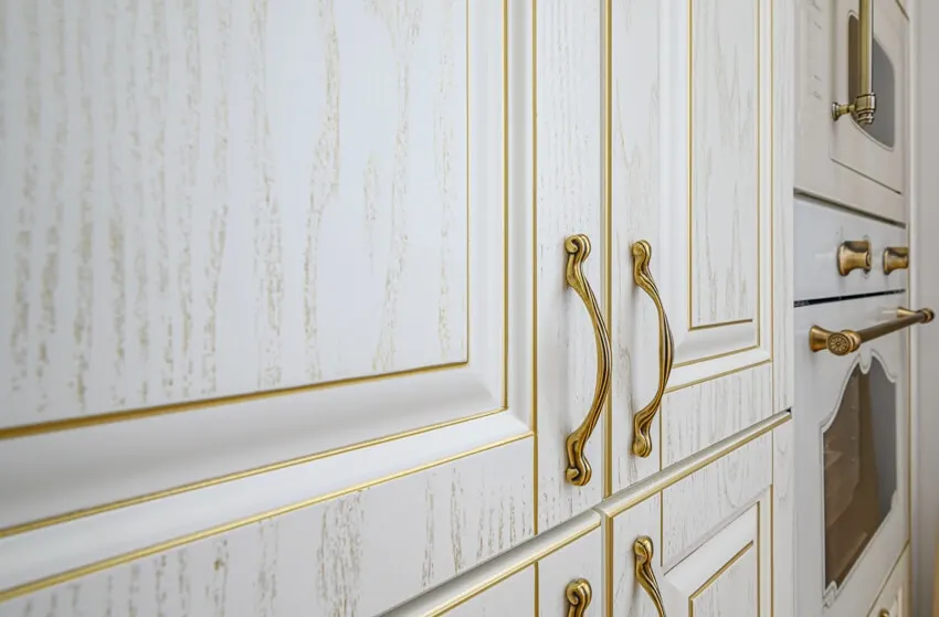 Cerused oak kitchen cabinets with gold handles