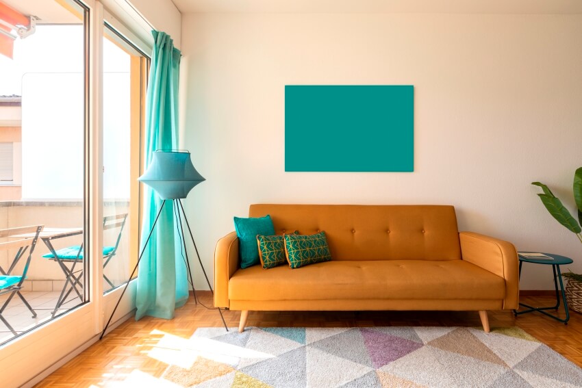 Chic room with some turquoise accents, zesty hued sofa and cushions 