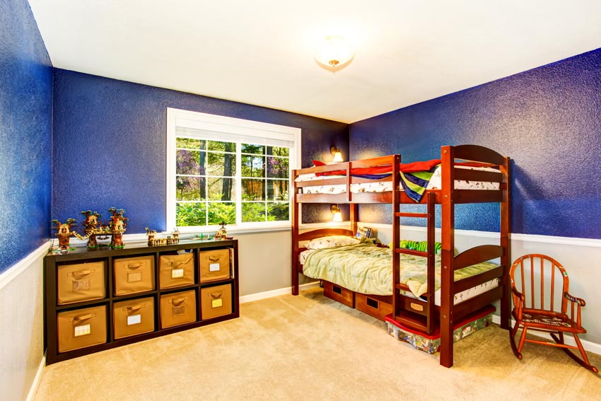 Children's bedroom with bunk bed, window, blue wall, mattress, pillow and chair 
