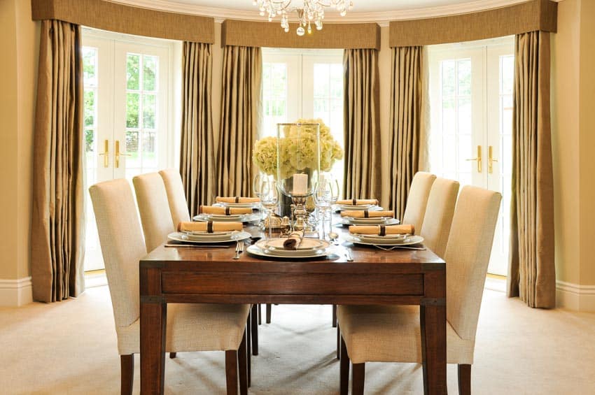 Dining room with centerpiece, table, chairs, and motorized curtains