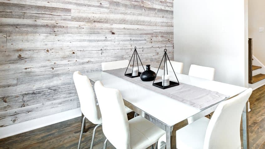 Dining room with wooden shiplap wall design, tables and chairs