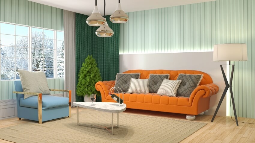 Earthy color vibe room with orange rust sofa and turquoise walls