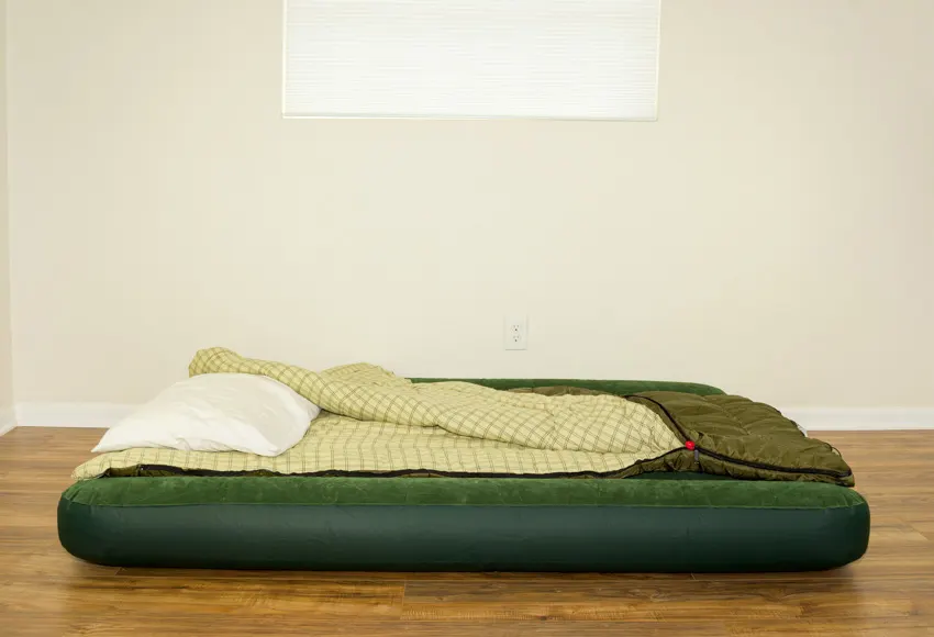 Empty room with green air mattress