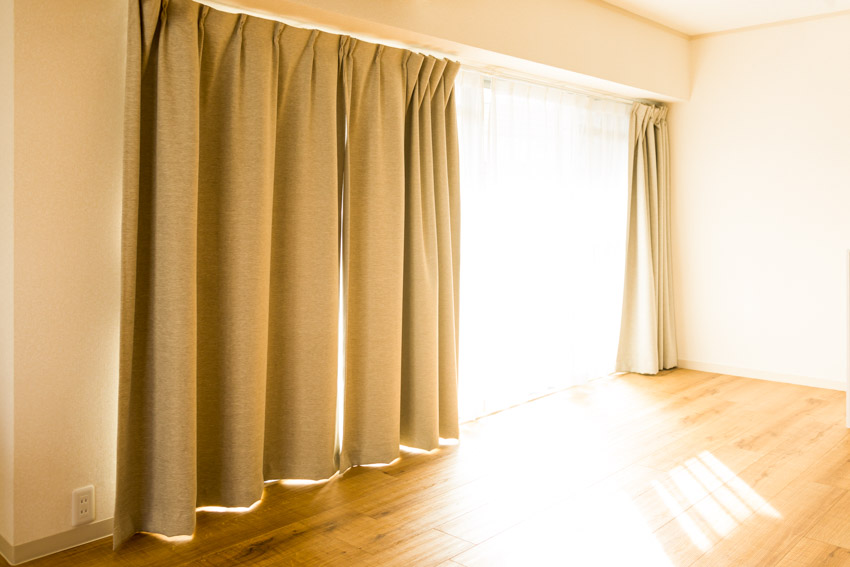 Empty room with wood floor, polyester curtain, and window