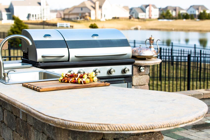 Epoxy countertop for outdoor kitchens with sink, faucet, and barbecue grill