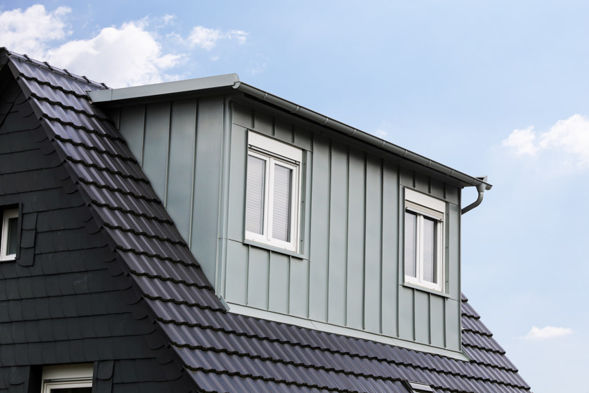 House dormer with metal wall cladding, windows, and flat roof