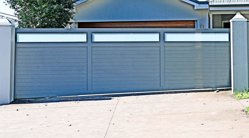 House driveway with sliding gate and pillars