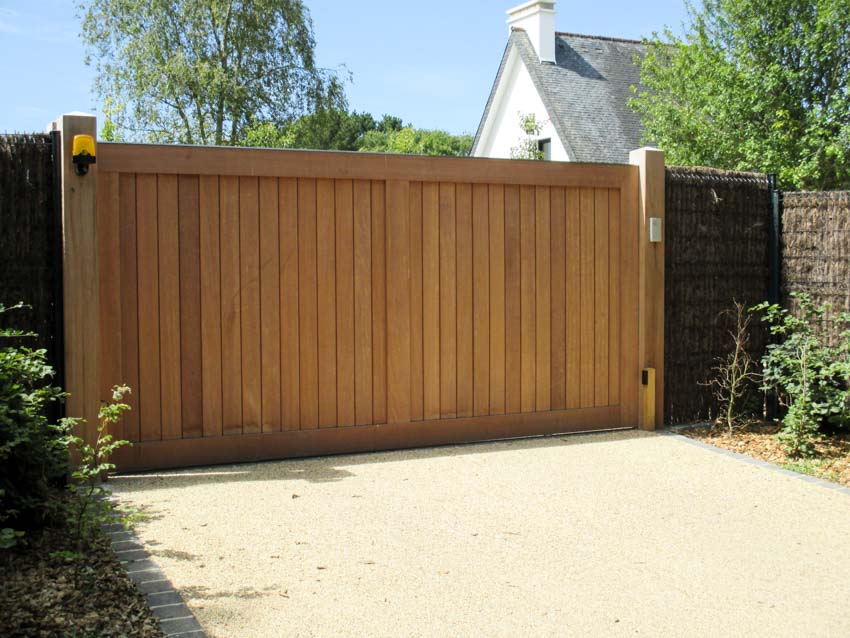 House exterior with sliding garden gate made of wood