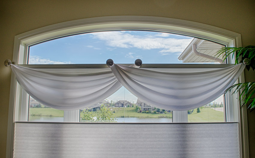 House interior arched window with white tier curtain
