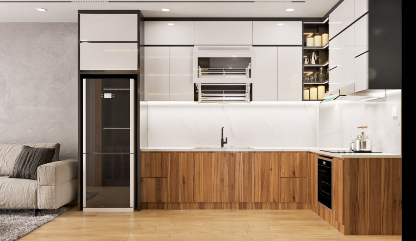 Kitchen with backsplash, sink, faucet, slab cabinet doors, and wood flooring