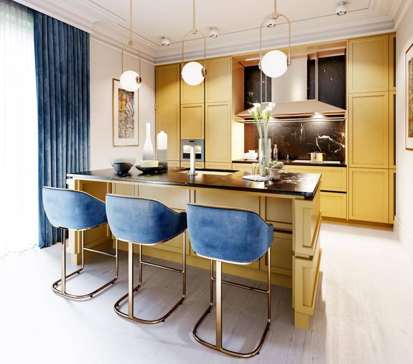 Quartz countertop, yellow cabinets, pendant lights and blue curtains