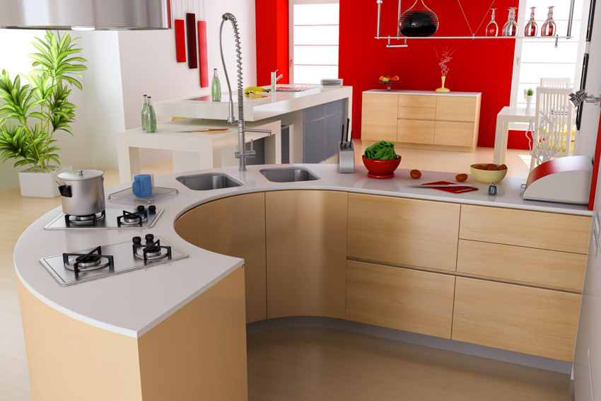 Kitchen with curved cabinets, countertop, stove, sink, faucet, and indoor plant