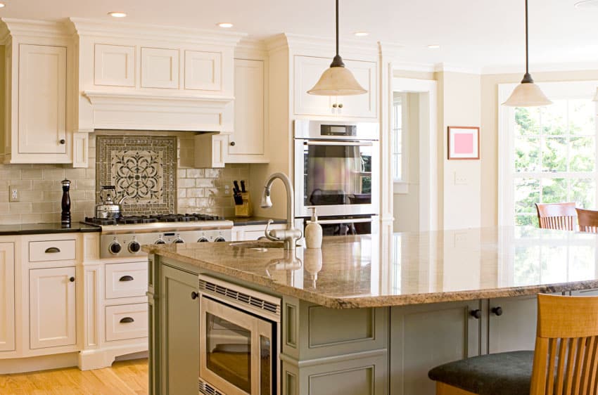 Kitchen with framed cabinets, center island, countertops, backsplash, pendant lights, oven, and range hood