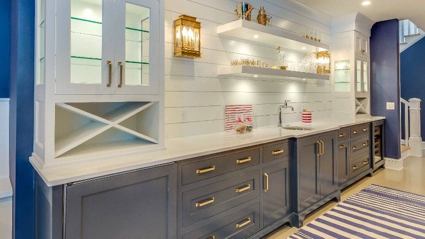 Kitchen with open cabinetry, blue drawers with gold handles and sliding door