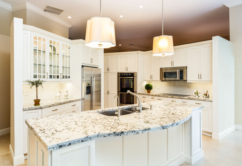 Kitchen with lighter hued backsplash, and granite countertops