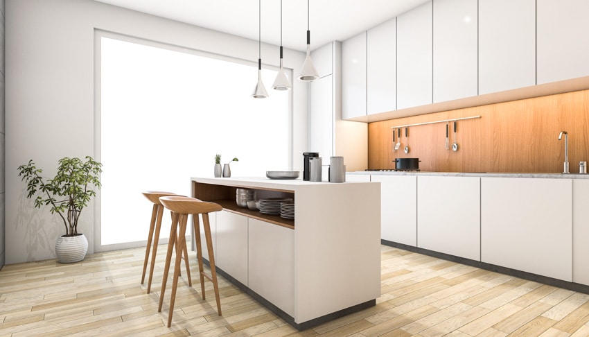 Kitchen with island, stools, wood floor, wood grain backsplash, pendant lighting, and window