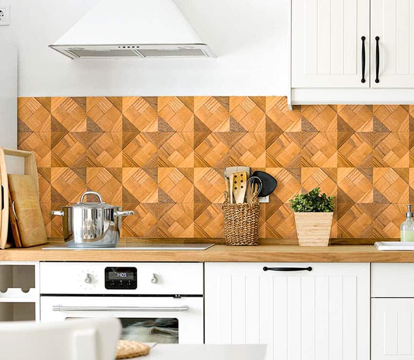 Kitchen with peel and stick wood tile backsplash, countertop, cabinets, and range hood