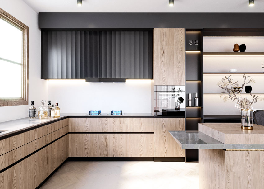 Kitchen with fluted cabinets, floating shelves, countertop, stove, range hood, and windows