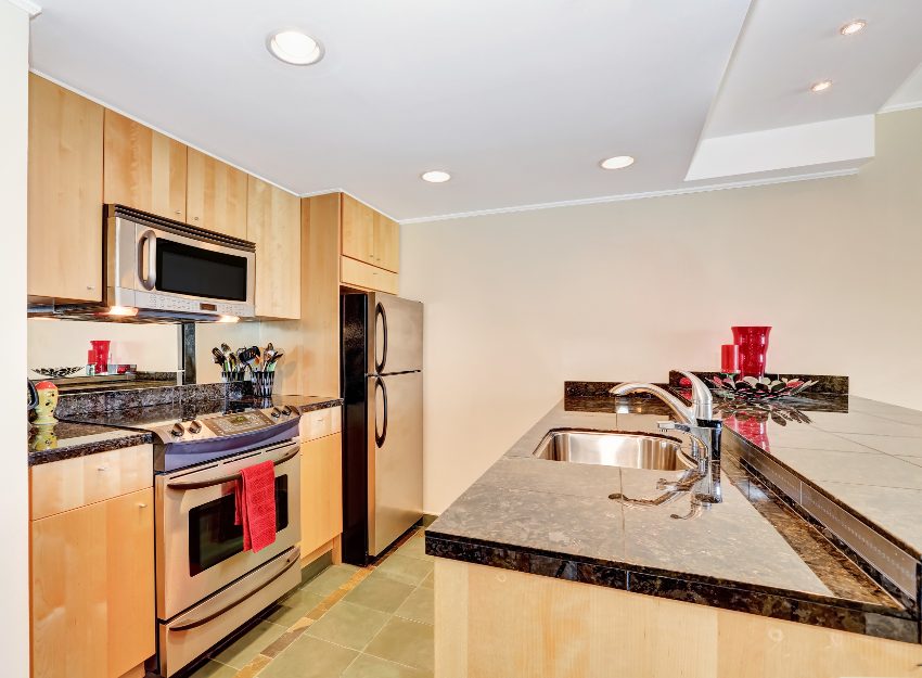 Kitchen with stainless steel appliances, tile floors, granite countertops and plywood kitchen cabinets