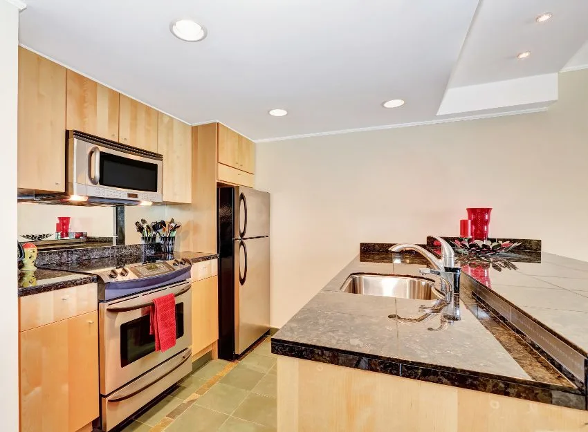 Kitchen with stainless steel appliances, tile floors, granite countertops and plywood kitchen cabinets