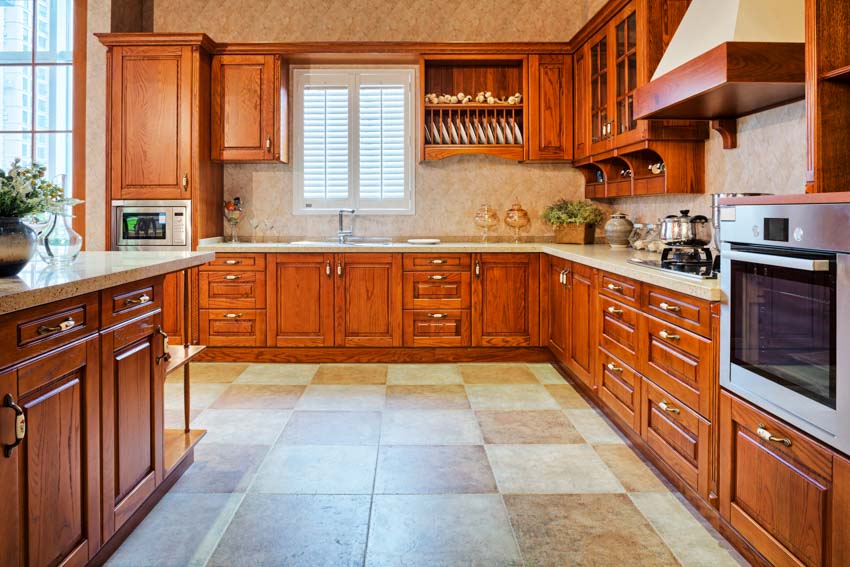 L-shaped counters, travertine floor tiles and chrome finish oven