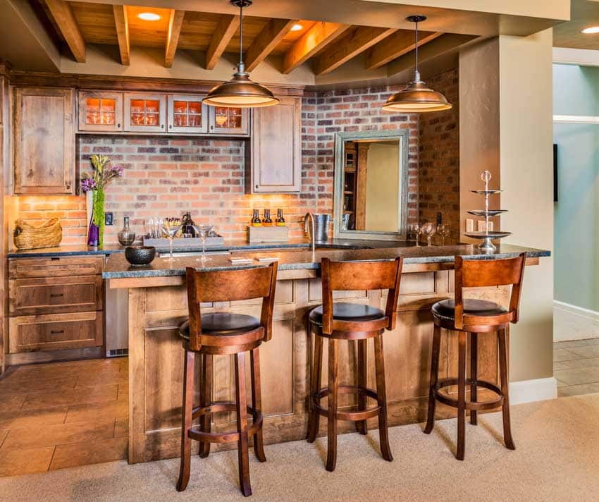 Kitchen with wet built-in bar stools, brick backsplash, wood counter, ceiling lights, and exposed beam ceiling