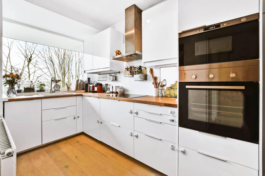 Kitchen with modern cabinets, countertop, wood floor, oven