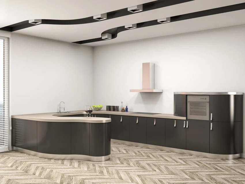 Modern kitchen with wood herringbone floors and black curved cabinets