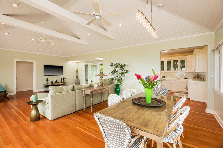 Living room and dining room combined with beadboard ceiling, and fans