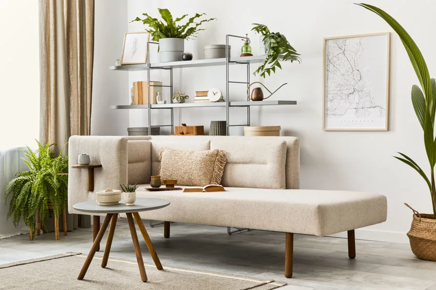 Room with chaise lounge, table and metal bookshelf