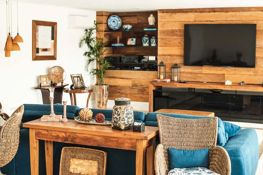 Room with farmhouse table, wicker chairs, blue couch and shiplap wall