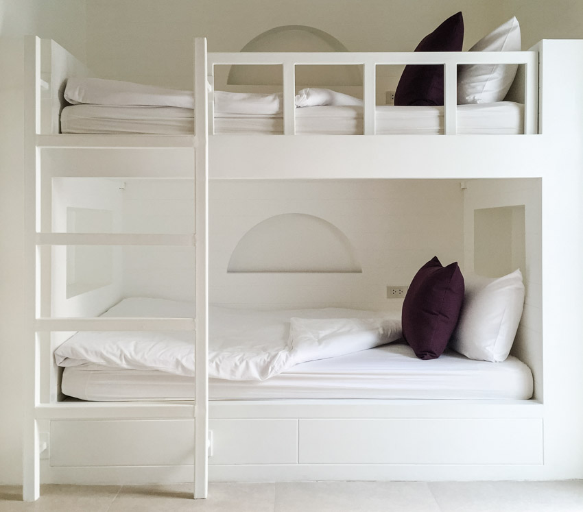 Low-profile bunk with mattress, and pillows in a minimalist bedroom