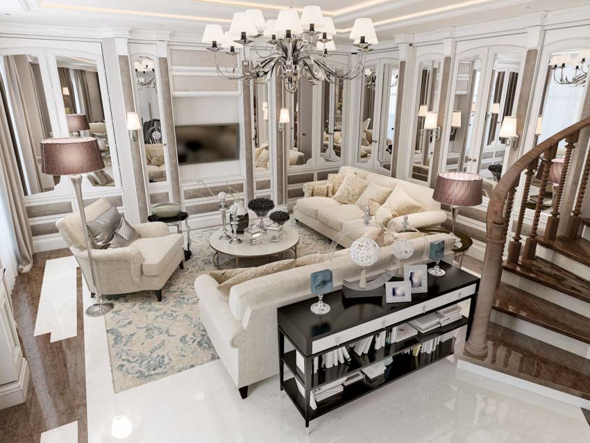 Luxurious living room with sofa, chairs, lamp, rug, coffee table, mirror wall panels, and sofa table