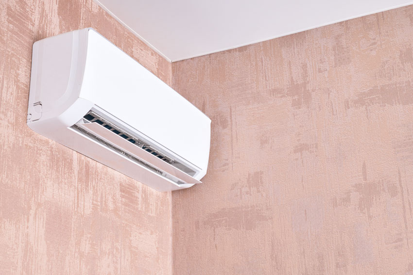 Mini split air conditioner on pastel pink walls