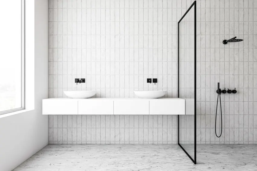 Minimalist bathroom with white kit kat tile wall, floating vanity, sink, faucet, divider and shower area