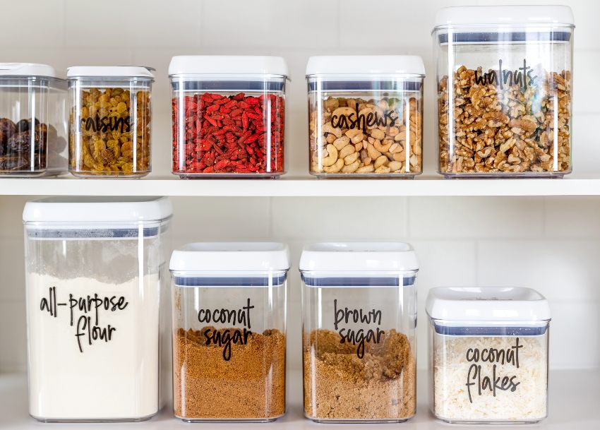 Neat deep pantry organization with labeled food ingredients in plastic storage containers