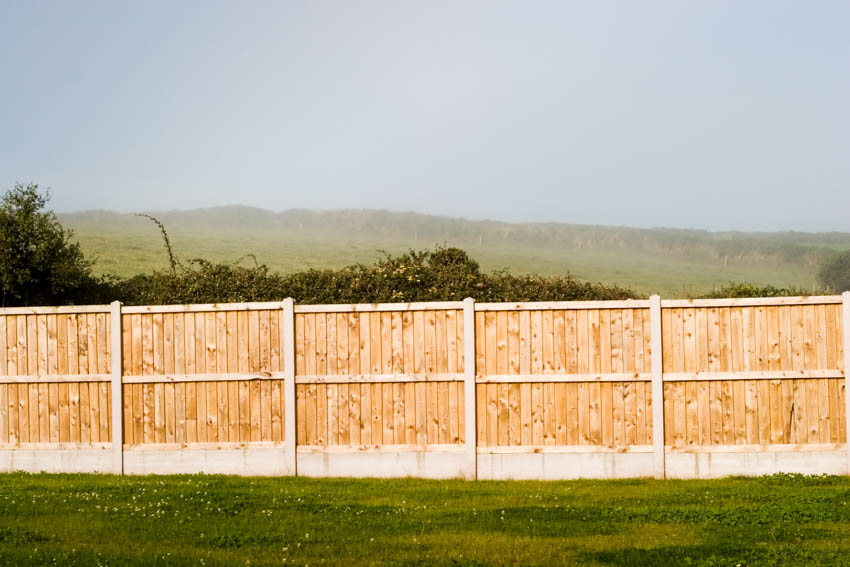 Cedar wood fence and concrete foundation