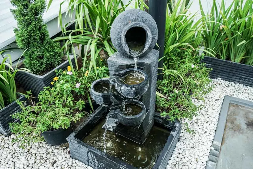 Cascading type of fountains with gravel rocks